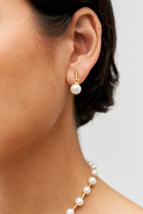 Profile view of model wearing the Oroton Asta Stud Drop Earrings in Worn Gold/Pearl and Brass material for Women . IP:2