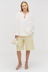 Profile view of model wearing the Oroton Tunic Shirt in Antique White and 100% silk for Women . IP:3