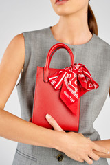 Profile view of model wearing the Oroton Ivy Mini Top Handle Tote in Dark Ruby and Saffiano leather material for Women