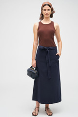 Profile view of model wearing the Oroton Clover Poplin Skirt in North Sea and 100% Cotton for Women