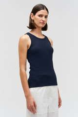 Profile view of model wearing the Oroton Lottie Rib Tank in North Sea and 92% Cotton / 8% Spandex for Women . IP:4