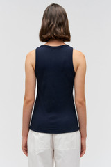 Profile view of model wearing the Oroton Lottie Rib Tank in North Sea and 92% Cotton / 8% Spandex for Women . IP:5