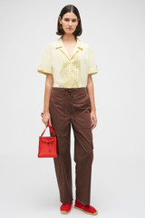 Profile view of model wearing the Oroton Scout Poplin Cargo Pant in Chocolate and 100% Cotton for Women
