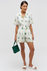 Profile view of model wearing the Oroton Greenhouse Floral Camp Shirt in Mist and 100% Linen for Women .