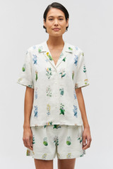 Profile view of model wearing the Oroton Greenhouse Floral Camp Shirt in Mist and 100% Linen for Women .