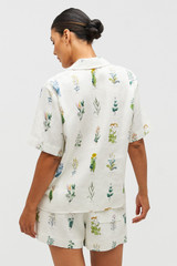 Profile view of model wearing the Oroton Greenhouse Floral Camp Shirt in Mist and 100% Linen for Women .