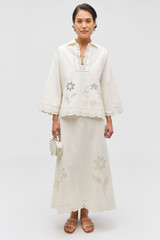 Profile view of model wearing the Oroton Table Cloth Lace Skirt in Soft Cream and 48% Cotton 52% Hemp for Women