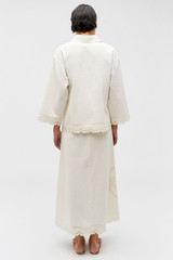 Profile view of model wearing the Oroton Table Cloth Lace Skirt in Soft Cream and 48% Cotton 52% Hemp for Women
