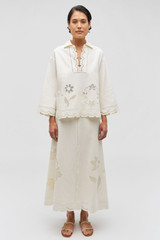 Profile view of model wearing the Oroton Table Cloth Lace Skirt in Soft Cream and 48% Cotton 52% Hemp for Women