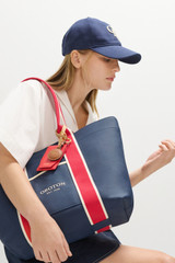 Profile view of model wearing the Oroton Oro Logo Cap in North Sea and High-quality 100% cotton material for Women . IP:4