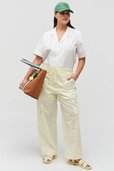 Profile view of model wearing the Oroton Scout Poplin Cargo Pant in Lemon and 100% Cotton for Women