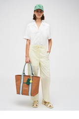 Profile view of model wearing the Oroton Posy Ruffle Camp Shirt in White and 100% Cotton for Women