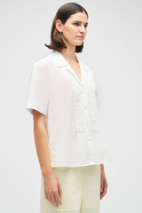 Profile view of model wearing the Oroton Posy Ruffle Camp Shirt in White and 100% Cotton for Women