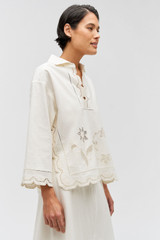 Profile view of model wearing the Oroton Table Cloth Lace Top in Soft Cream and 48% Cotton 52% Hemp for Women