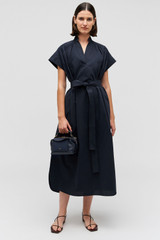 Profile view of model wearing the Oroton Rae Gathered Dress in North Sea and 100% cotton for Women .