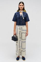 Profile view of model wearing the Oroton Bandana Pant in Ecru and 100% cotton twill with leather logo patch for Women . IP:2