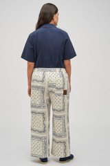 Profile view of model wearing the Oroton Bandana Pant in Ecru and 100% cotton twill with leather logo patch for Women . IP:9