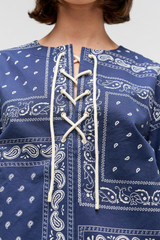 Profile view of model wearing the Oroton Bandana Lace Up Top in North Sea and 100% cotton twill leather logo patch for Women . IP:6