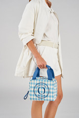 Profile view of model wearing the Accessories Kaia Lunch Bag in Cobalt Blue Check and Check Straw for 