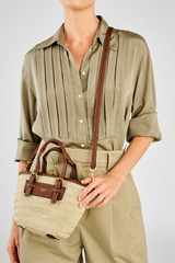 Profile view of model wearing the Oroton Camille Straw Small Tote in Natural and Woven straw material for Women . IP:4