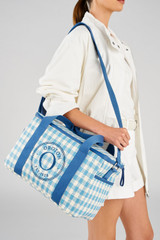 Profile view of model wearing the Accessories Kaia Picnic Bag in Cobalt Blue Check and Check Straw for 