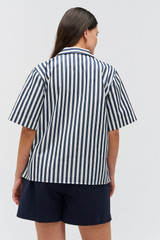 Profile view of model wearing the Oroton Stripe Camp Shirt in North Sea and 100% cotton twill with leather logo patch for Women