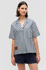 Profile view of model wearing the Oroton Stripe Camp Shirt in North Sea and 100% cotton twill with leather logo patch for Women