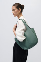 Profile view of model wearing the Oroton Emilia Tote in Mineral and Pebble leather exterior for Women