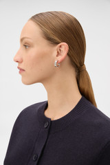 Profile view of model wearing the Oroton Heather Hoops in Silver and Premium brass material for Women . IP:2