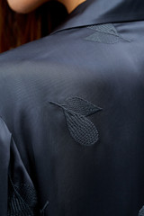 Profile view of model wearing the Oroton Embroidered Leaf Short Sleeve Camp Shirt in Slate and 100% viscose fabric for Women . IP:6
