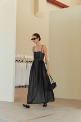 Profile view of model wearing the Oroton Sheer Bodice Dress in Black and 100% cotton material for Women .