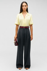 Profile view of model wearing the Oroton Embroidered Leaf Short Sleeve Camp Shirt in Lemon and 100% viscose fabric for Women . IP:2