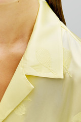 Profile view of model wearing the Oroton Embroidered Leaf Short Sleeve Camp Shirt in Lemon and 100% viscose fabric for Women . IP:6