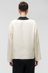 Profile view of model wearing the Oroton Graphic Poppy Ls Camp Shirt in Cream and 100% silk fabric for Women . IP:5