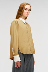 Profile view of model wearing the Oroton Crisp Poplin Shirt in SOFT CAMEL and 100% cotton fabric for Women .