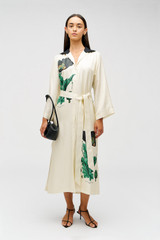 Profile view of model wearing the Oroton Graphic Poppy Column Dress in Cream and 100% silk fabric for Women .