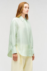 Profile view of model wearing the Oroton Ls Silk Shirt in Sea Mist and 100% silk dupion fabric with a subtle horizontal slub texture for Women . IP:4