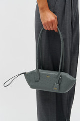 Profile view of model wearing the Oroton BREEZE TEXTURE BAGUETTE in Dark Slate and Embossed leather for Women