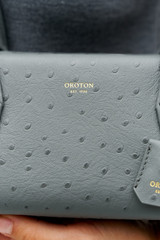 Profile view of model wearing the Oroton BREEZE TEXTURE BAGUETTE in Dark Slate and Embossed leather for Women
