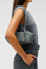 Profile view of model wearing the Oroton BREEZE TEXTURE BAGUETTE in Dark Slate and Embossed leather for Women