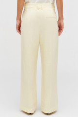 Profile view of model wearing the Oroton Pleat Slouch Pant in Lemon Butter and 58% viscose, 42% linen blend for Women . IP:6