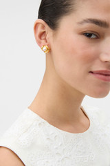 Profile view of model wearing the Oroton Wave Studs in Worn Gold/Pearl and Premium brass material for Women . IP:2