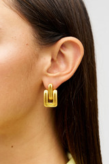 Profile view of model wearing the Oroton James Earrings in Worn Gold and Premium brass material for Women . IP:2