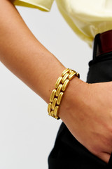 Profile view of model wearing the Oroton James Bracelet in Worn Gold and Premium brass material for Women . IP:2