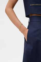 Profile view of model wearing the Oroton Mathilde Bracelet in Worn Gold and Premium brass material for Women . IP:2