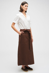 Profile view of model wearing the Oroton Clover Poplin Skirt in Chocolate and 100% Cotton for Women