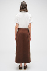 Profile view of model wearing the Oroton Clover Poplin Skirt in Chocolate and 100% Cotton for Women