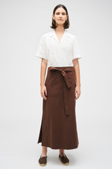 Profile view of model wearing the Oroton Clover Poplin Skirt in Chocolate and 100% Cotton for Women