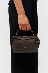Profile view of model wearing the Accessories MICA MINI BOWLER in Dark Chocolate and Premium pebble leather for Women
