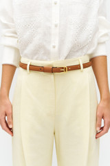 Profile view of model wearing the Oroton Cali 19MM Belt in Amber and Premium smooth leather for Women . IP:2